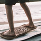 Person standing on the Neuro Balance Board, emphasizing its role in improving balance and stability