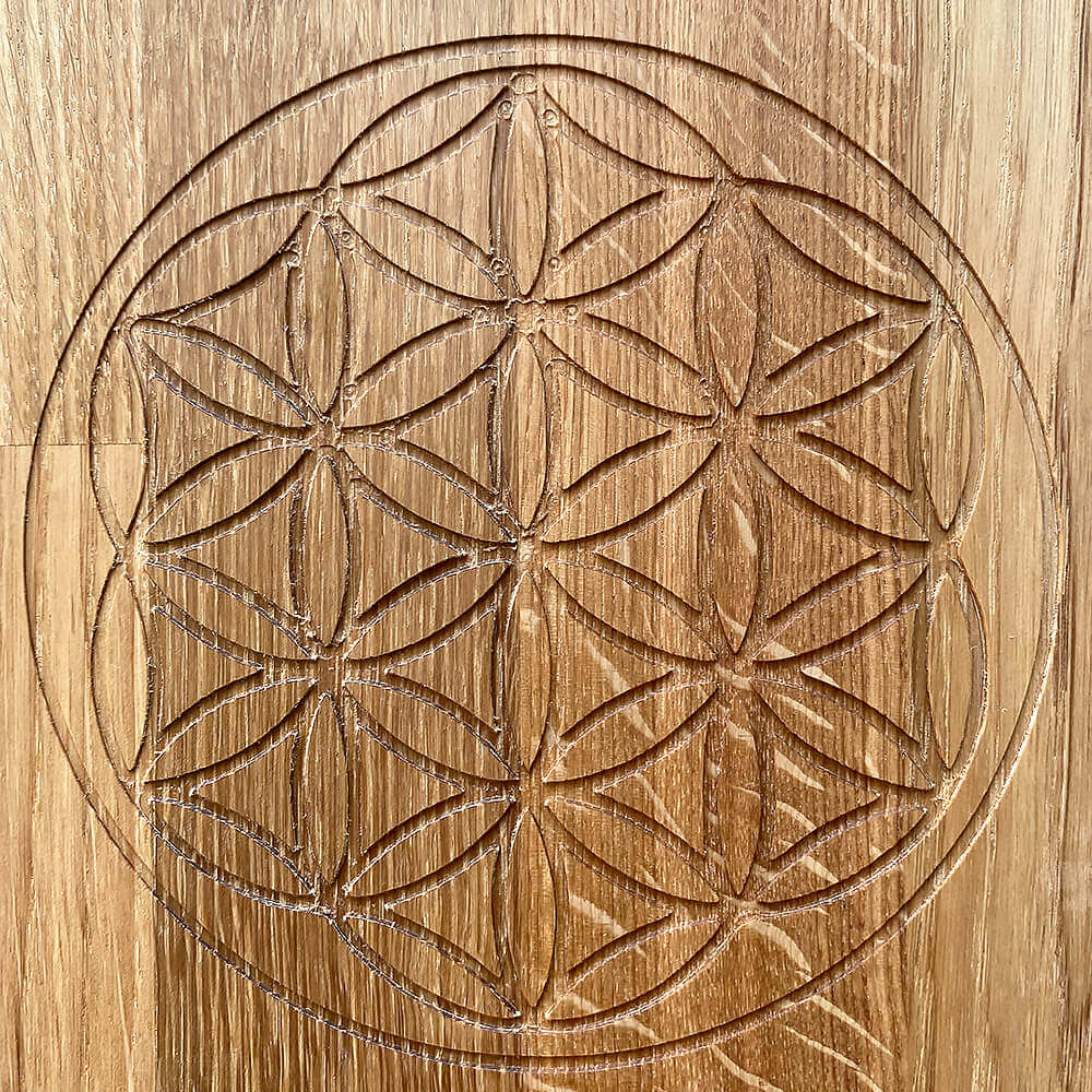 Detailed view of the Flower of Life design on the Wooden Oak Sadhu Board, symbolizing energy alignment.