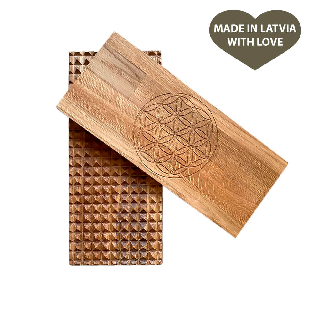 Foot reflexology massage using the Wooden Oak Sadhu Board to enhance circulation and relax the body.