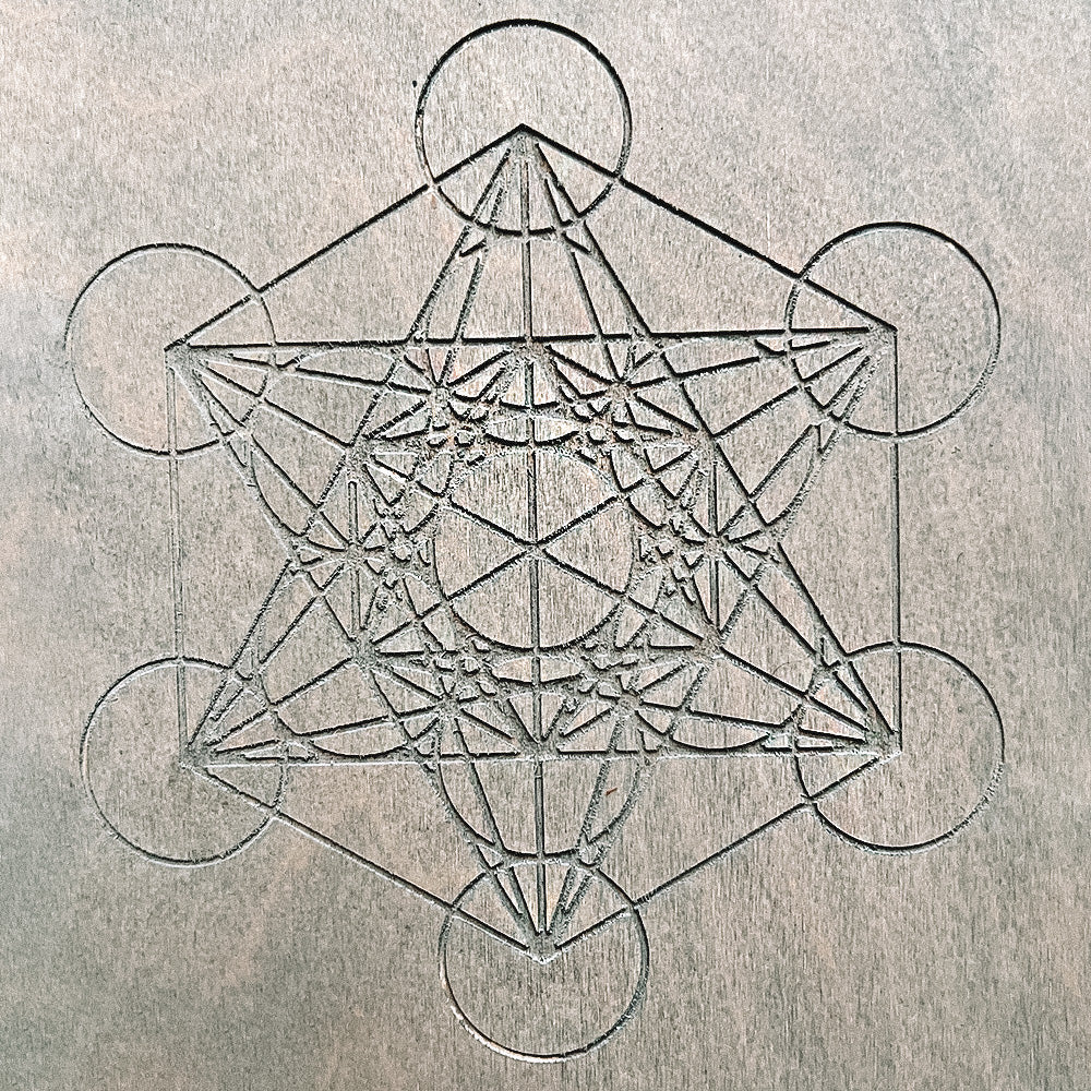 Close-up of the sacred Metatron’s Cube engraving on the Sadhu board.